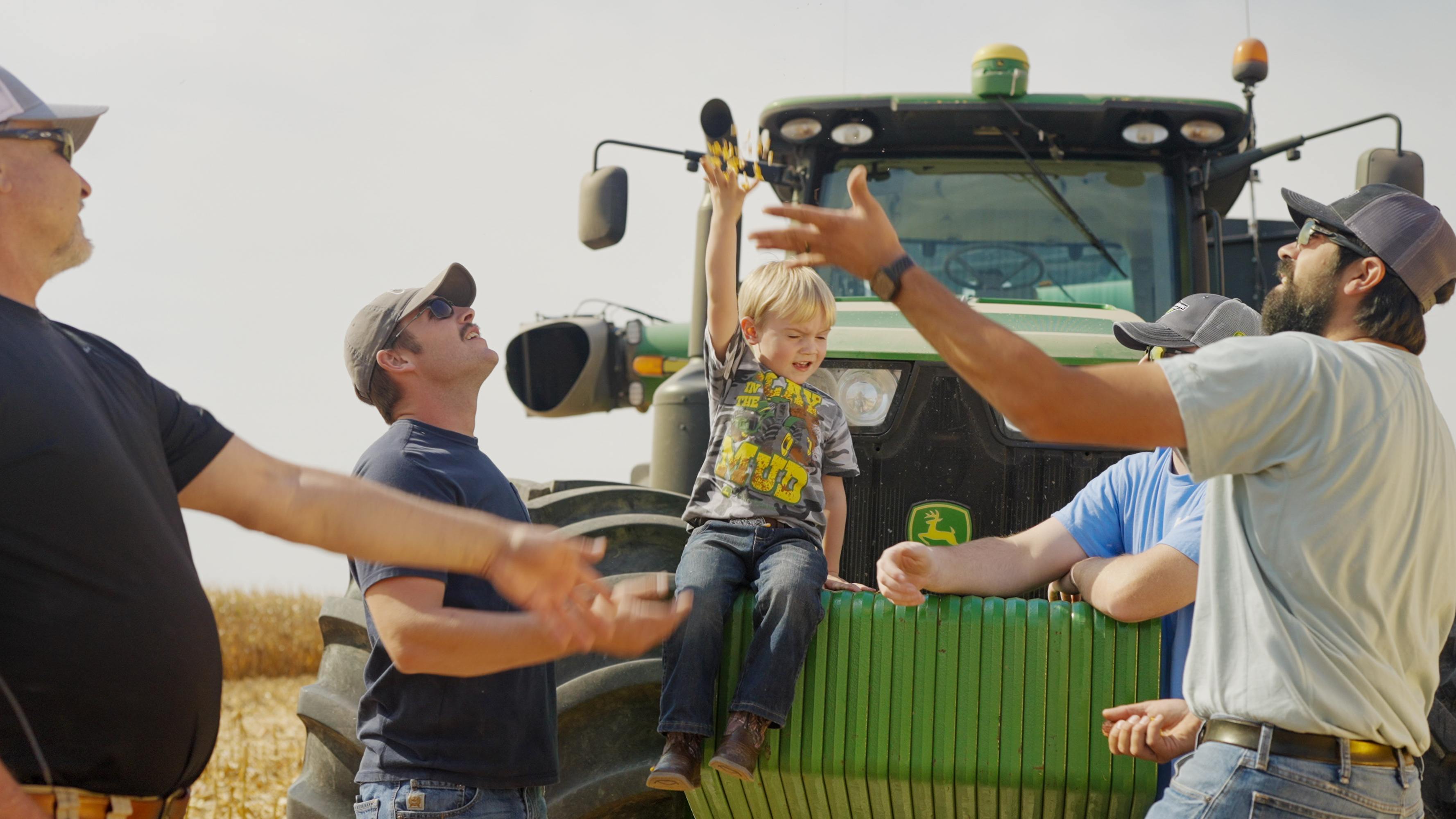 farmers in a field with corn